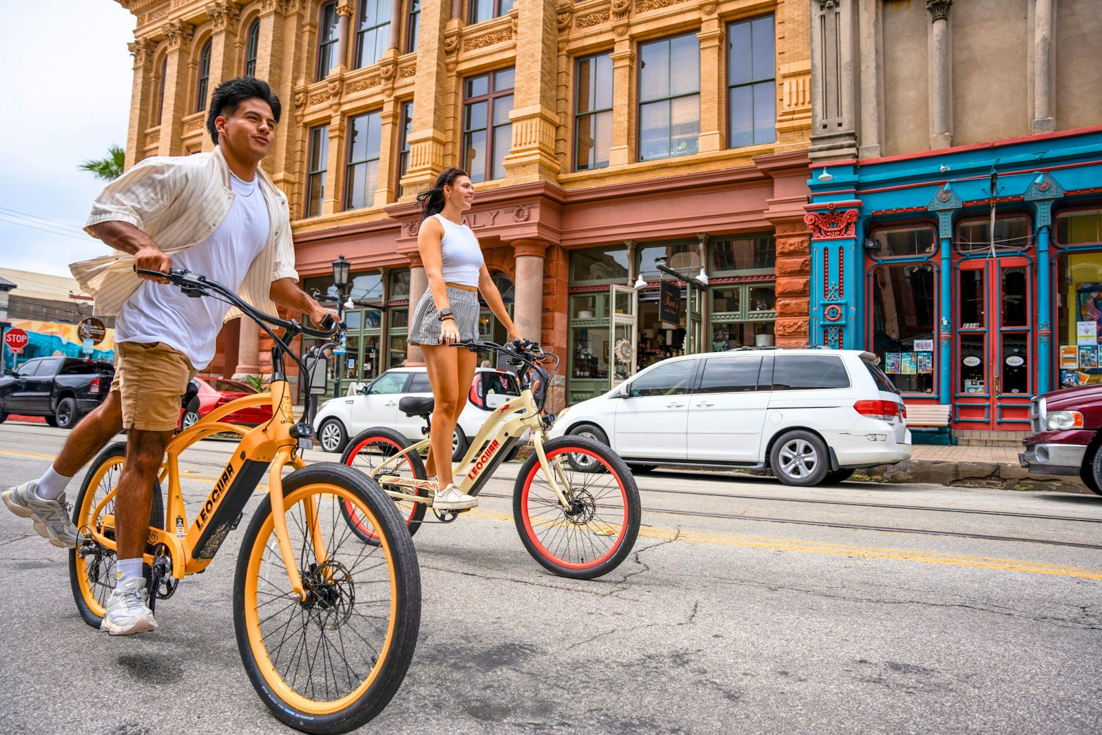 A man riding a bike down the middle of a street